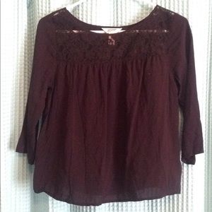 Black silky material shirt. Lace design at top.